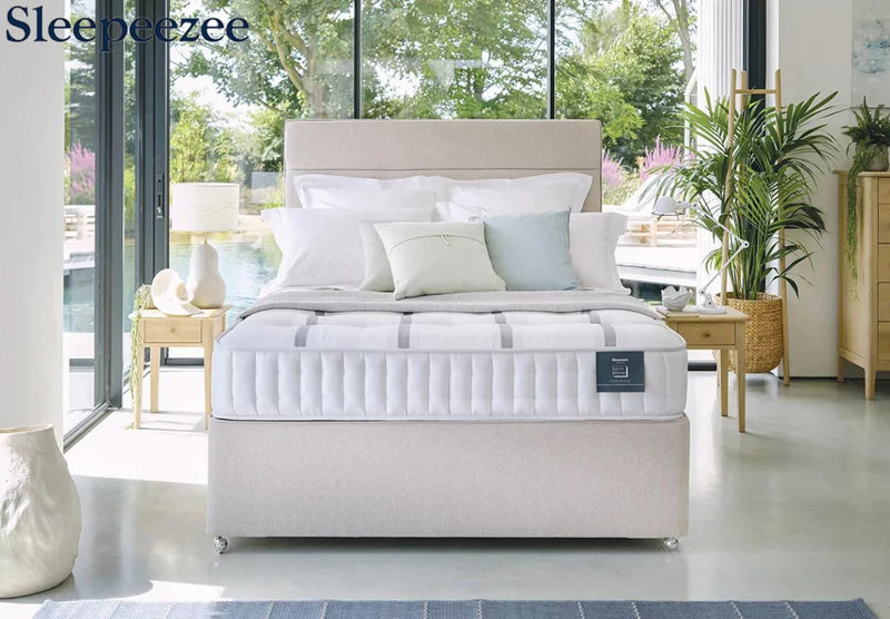 Neutral bedroom showcasing mattress, pillows and a throw