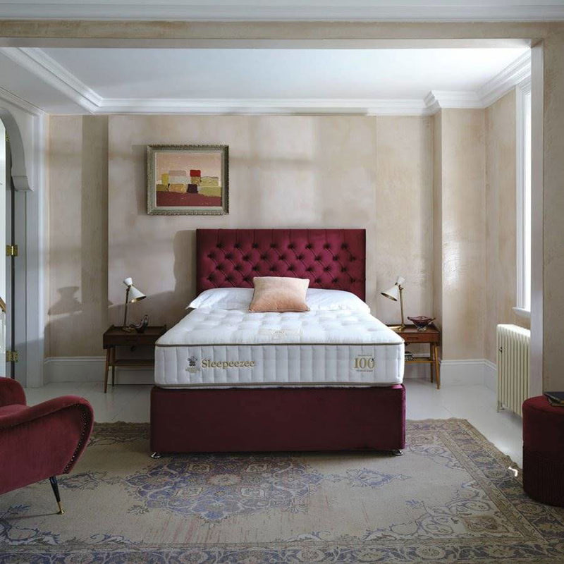 Luxury bed in a modern bedroom with bedside tables and pictures
