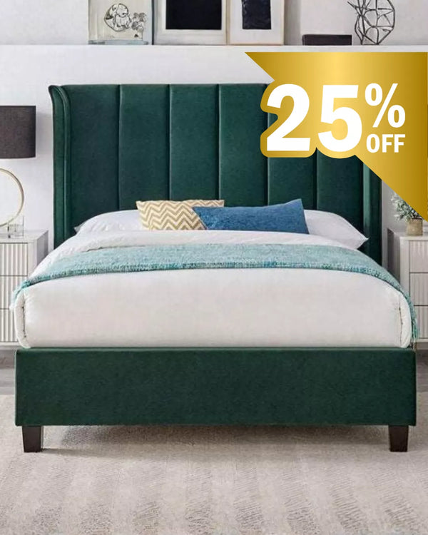 Green upholstered Limelight bed frame with a 25% off label in a bedroom setting